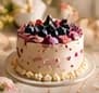 White cake topped with fresh blueberries and blackberries