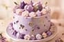 Lilac frosted cake decorated with piped flowers